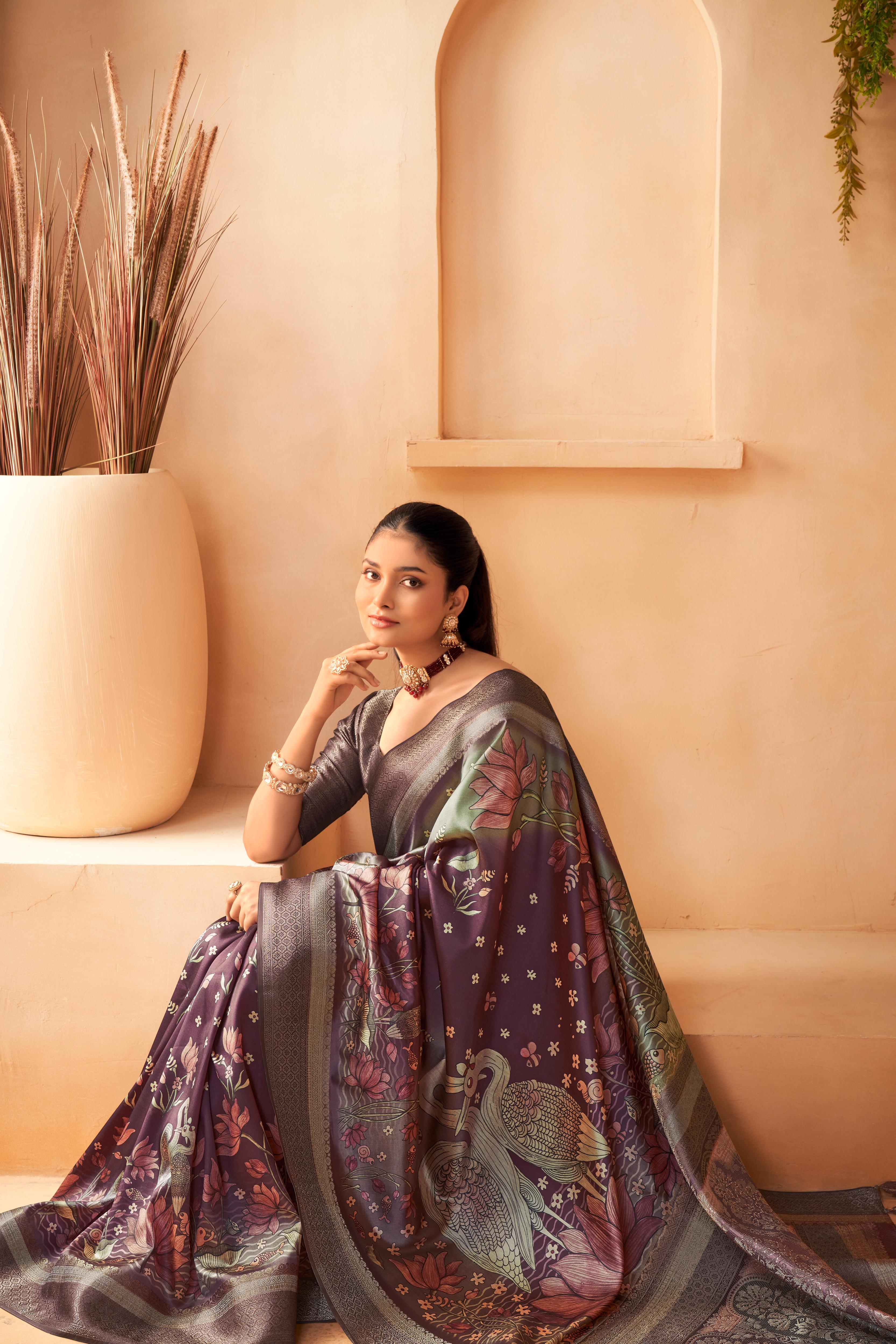 Women wearing a Wine Colour Silk Saree with Jacquard palu and birds and lotus is made