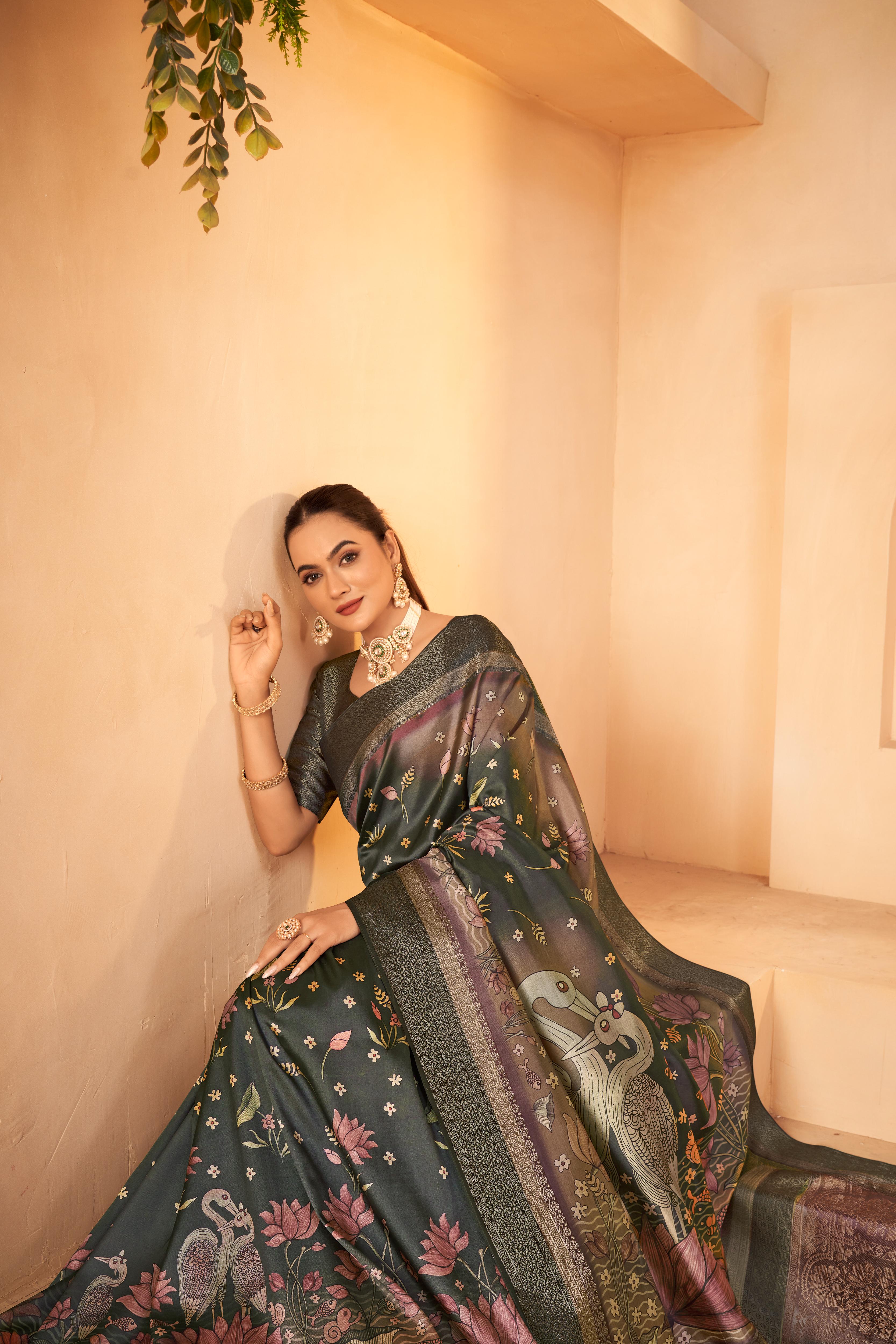 woman is sitting with the support of a wall wearing a Green Saree made of Silk fabric and Jacquard border