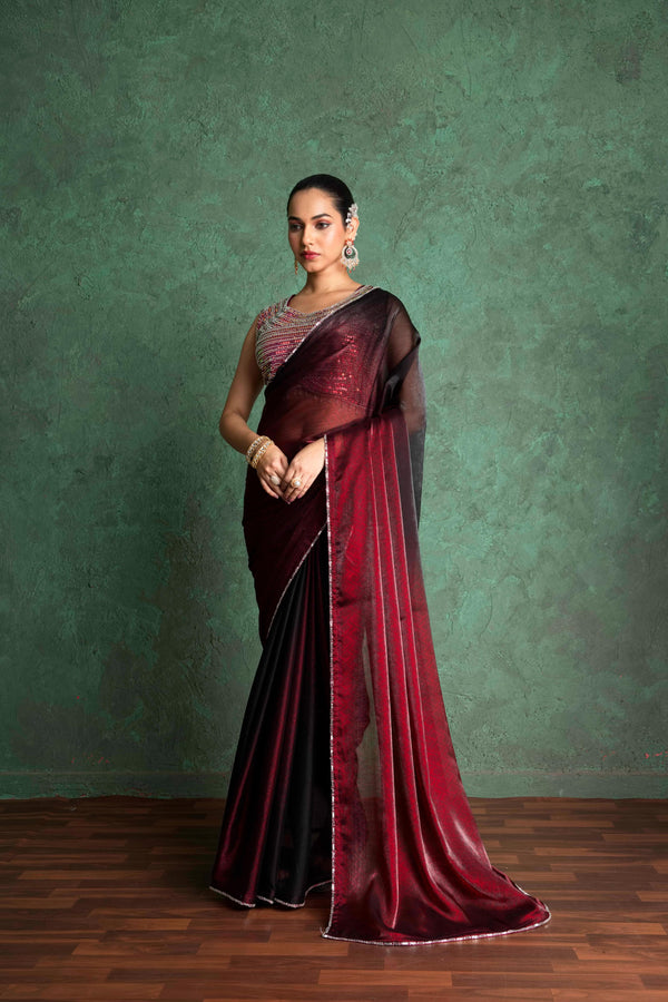 Red saree with a sequin blouse, styled with statement jewelry maroon saree with a sequin blouse, styled with statement jewelry