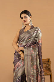 Wine colour silk saree with flowers and floral print is wore by a women 